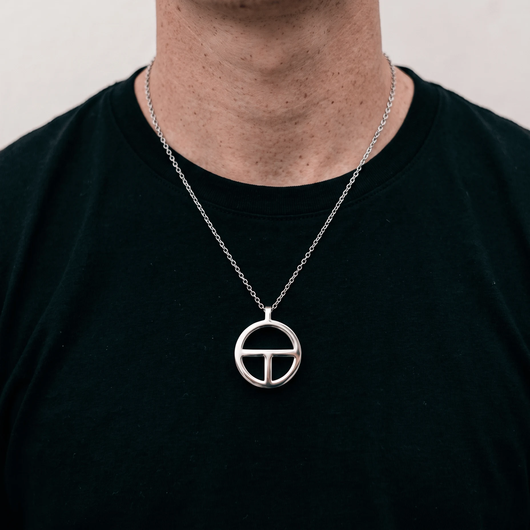 TOKIN breathing pendant worn on a silver chain